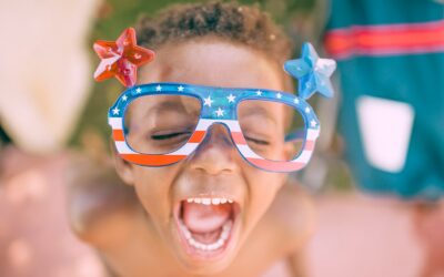 boy wearing American flag print eyeglasses sticking his mouth open