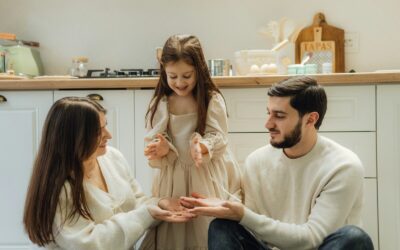 A group of people sitting around in a kitchen