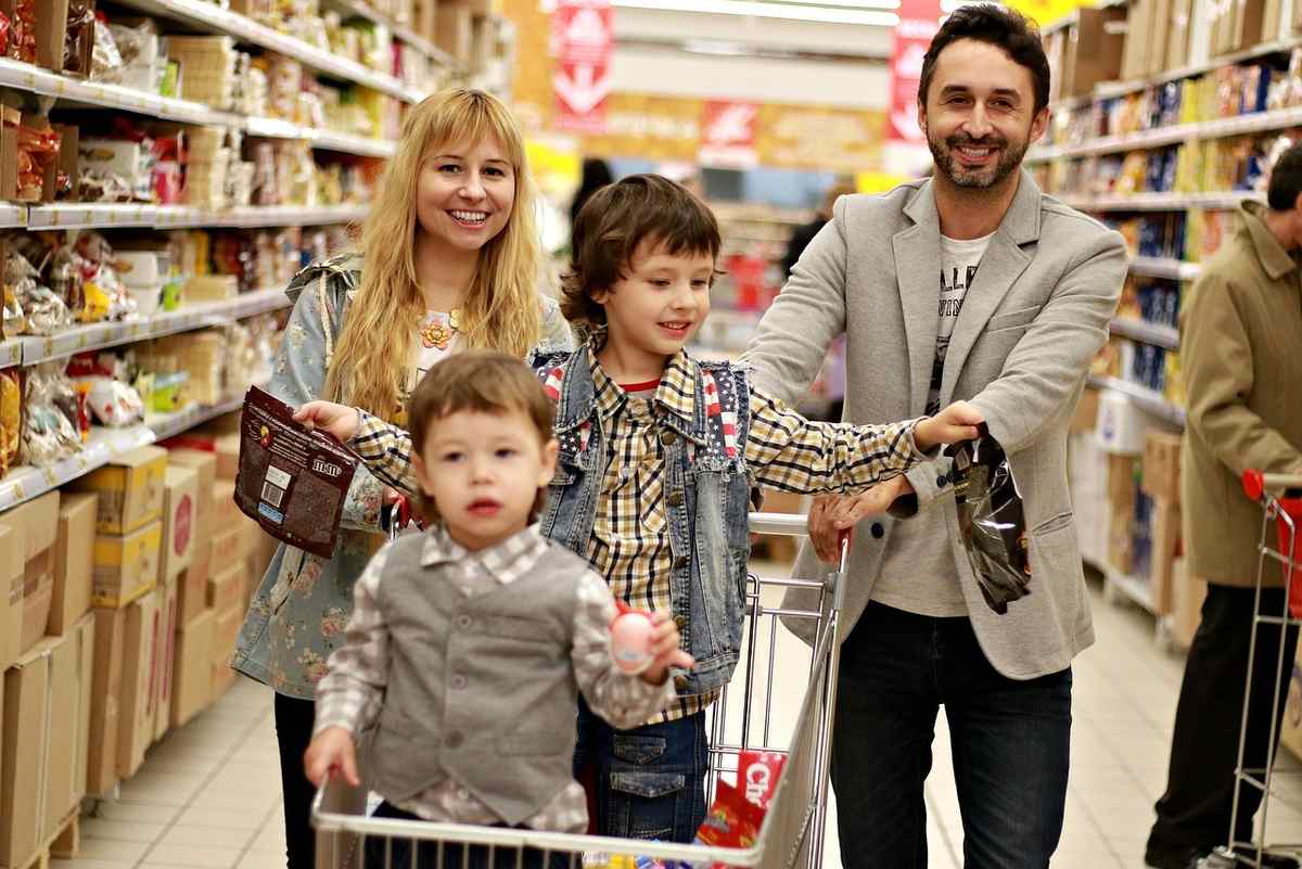 Une famille fait ses courses dans un couloir du supermarché